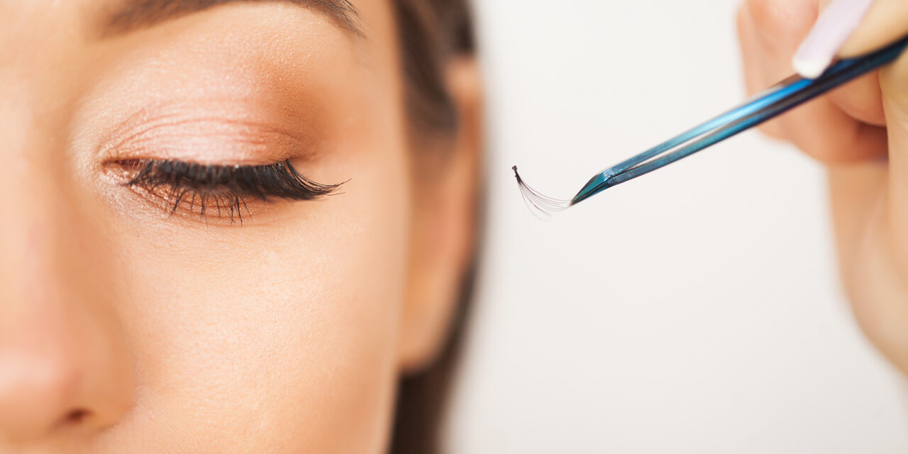Eyelashes extensions. Fake Eyelashes. Eyelash Extension Procedure. Professional stylist lengthening female lashes. Master and a client in a beauty salon.